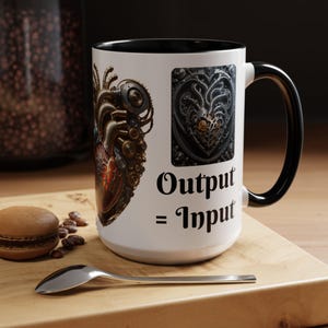 May include: White ceramic mug with a black handle and rim, featuring a steampunk heart design and the text "Output = Input." The mug has a detailed illustration of a mechanical heart and a decorative heart-shaped emblem.