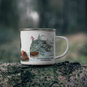 May include: White enamel camping mug featuring a forest scene with a 4x4 vehicle, a tent, and a bird. The mug has the text "Born to roam, built to conquer" and "Day off". The mug is sitting on a log.