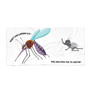 May include: A white rectangular towel featuring a cartoon mosquito with a brown thorax, purple abdomen, and blue wings, accompanied by the text WHAT GHA LOOKING AT? and a smaller grey mosquito with the text AND WHO ARE YOU TO JUDGE?