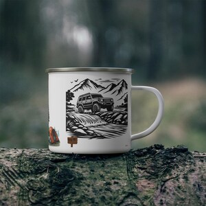 May include: White enamel camping mug with a black and white illustration of a 4x4 vehicle crossing a river in a mountain landscape. The mug also features a tent and a sign that reads "Camp Off".
