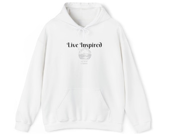 May include: A white hoodie with a front pocket and a drawstring. The text "Live Inspired" is printed in black script above a small illustration. A casual, comfortable garment.