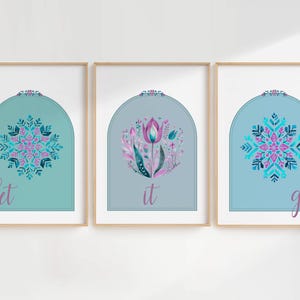May include: Three framed prints with a blue and teal background. Each print features a snowflake design and the words "let", "it", and "go".