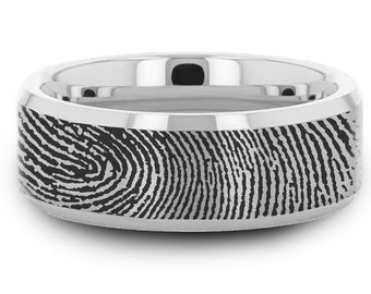 May include: A silver wedding band with a black fingerprint design engraved on the surface.