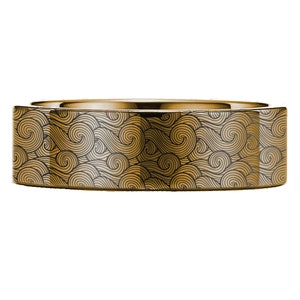 Può includere: Un anello dorato con un motivo a onde nero e oro.