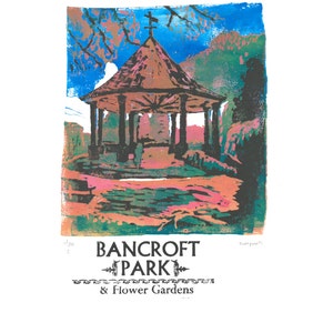 May include: A colorful linocut print of a gazebo in a park. The print is titled "Bancroft Park & Flower Gardens".
