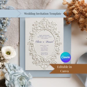 May include: A wedding invitation template featuring a white embossed design with an ornate oval frame. The invitation includes the names Olivia & Daniel, event details, and the text "Wedding Invitation Template" and "Editable in Canva".