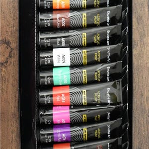 May include: A couple's date night DIY painting set with two iridescent heart-shaped glasses, two canvases, a set of 16 acrylic paints, two paint palettes, a set of brushes, and a silicone paint cup.