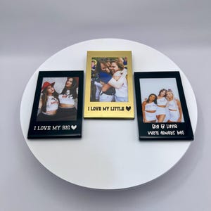 May include: Three photo frames with pictures of friends. The frames are black and gold. The text on the frames reads "I LOVE MY BIG", "I LOVE MY LITTLE", and "Big & Little We'll always be!"