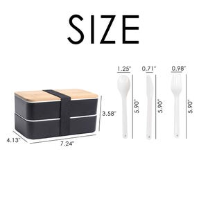 May include: A two-tiered lunch box with a black exterior and a wooden top. The lunch box measures 7.24 inches wide, 4.13 inches long, and 3.58 inches high. It comes with a matching spoon, fork, and knife, each measuring 5.90 inches long.