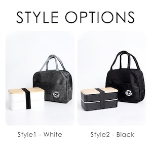 May include: Two lunch bag styles with matching lunch boxes. The first style is a gray lunch bag with a white lunch box and the second style is a black lunch bag with a black lunch box. Both lunch bags have a black handle and a black zipper. Both lunch boxes have a wooden top and a black bottom.