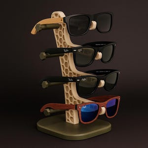 May include: A beige honeycomb-patterned sunglasses stand displaying four pairs of sunglasses. The stand has wooden arms to hold the glasses. The text "SHADE STAND" is at the top. The sunglasses have black and brown frames.