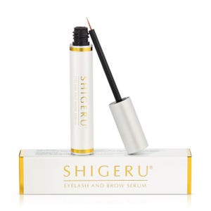 May include: A white bottle with a gold label that says "SHIGERU® Eyelash and Brow Serum". The bottle has a black applicator brush. The bottle is sitting on a white box with a gold label that says "SHIGERU® Eyelash and Brow Serum".