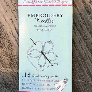 May include: A blue and white package of 18 hand sewing needles for embroidery. The package features a drawing of a needle and thread, and the text "Crafter's Collection Embroidery Needles". The package is from John James, Est. 1840.