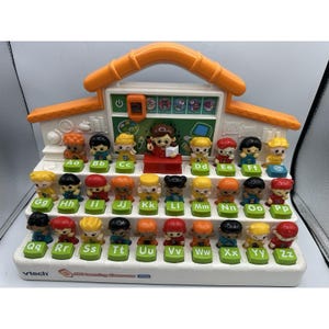 May include: An ABC Learning Classroom toy with an orange roof and white base. The toy features 26 small figurines, each representing a letter of the alphabet. The letters are printed on green blocks. The toy has a small chalkboard and a teacher figurine.