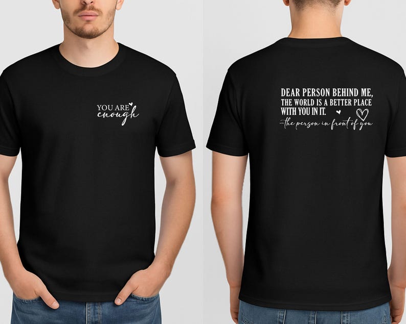 May include: Black t-shirt with white text on the front that reads "YOU ARE enough". The back of the shirt has the text "DEAR PERSON BEHIND ME, THE WORLD IS A BETTER PLACE WITH YOU IN IT. the person in front of you."