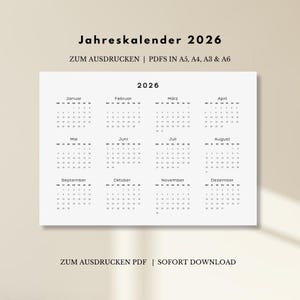 May include: A minimalist 2026 calendar in black and white. The calendar is displayed on a white background and includes the months of the year. Text at the top reads "Jahreskalender 2026" and "ZUM AUSDRUCKEN | PDFS IN A5, A4, A3 & A6".