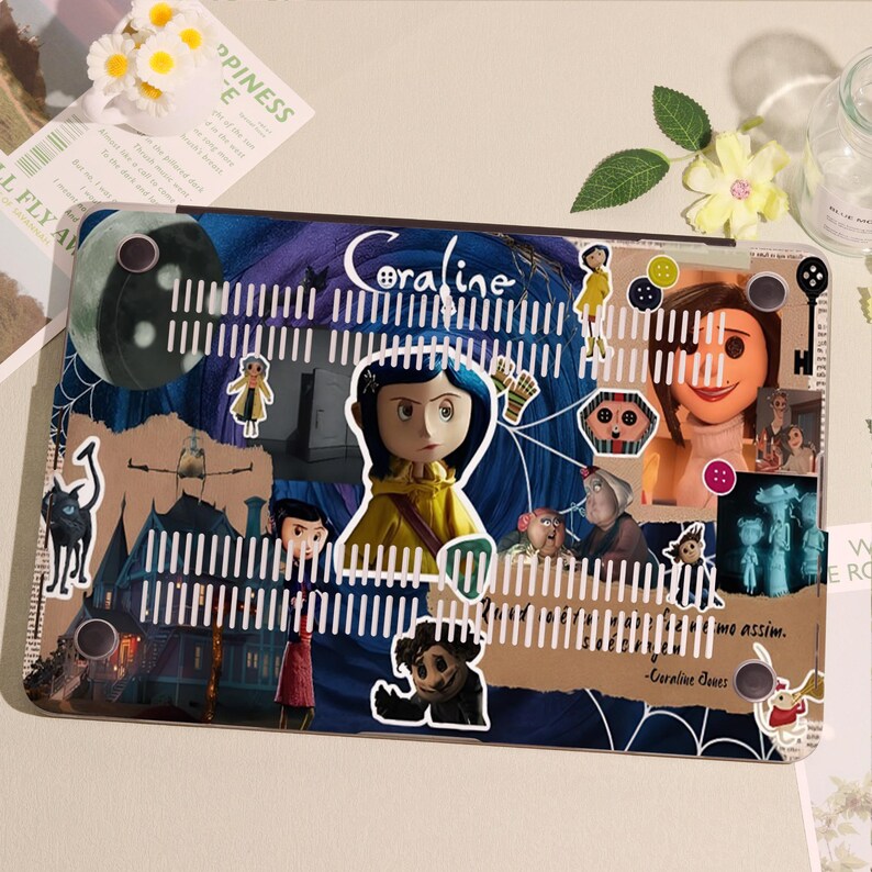 May include: A laptop case featuring a collage of images and characters from the movie "Coraline." The design includes the title "Coraline" in a stylized font, along with illustrations of the main character and other elements from the film. The case has a protective, hard shell.