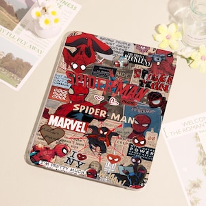 May include: A clear tablet case featuring a collage of Spider-Man comic book imagery. The design includes various Spider-Man illustrations, the Marvel logo, and text elements like "SPIDER-MAN" and "I NY". The case has a glossy finish.