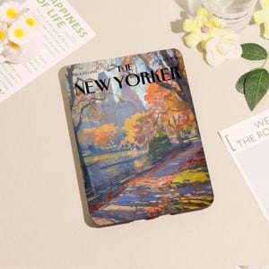 May include: A rectangular case with a colourful illustration of a park scene, including a lake, trees, and buildings. The cover reads "THE NEW YORKER" with "PRICE 23 CENTS" above. The artwork features autumnal colours.