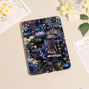 May include: A dark blue tablet case featuring a collage of images and text from the Tim Burton film, "Coraline." The design includes stars, moons, and the words "Witch Words." The case has a glossy finish.