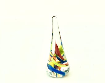 Hand sculpted clear glass ring holder with rainbow of colors swirled inside.