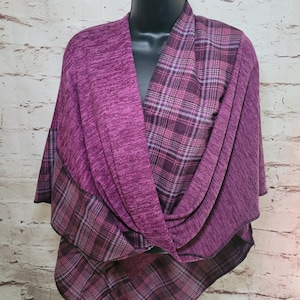 May include: A purple and black plaid infinity scarf with a soft, textured feel. The scarf is made of a lightweight fabric and is perfect for layering.