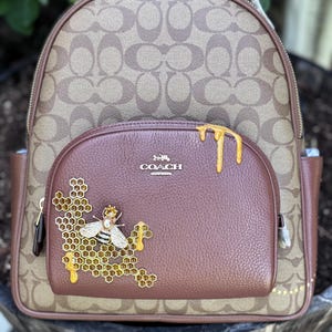 coach backpack bee print RARE Vintage 7441 Optic Monogram Bag Thanks it's Vintage Signature coated canvas and smooth leather Snap closure Attached split key ring and dogleash clip 2 (L) x 2 1/4 (H) Style No. Signature Canvas Coach Bee Print