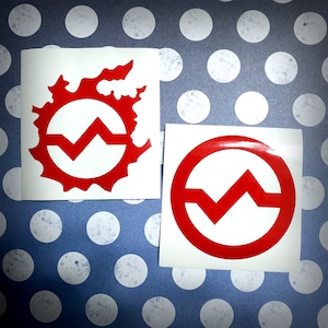 May include: Two red vinyl stickers on a white background. One sticker features a red circle with a zig-zag design inside. The other sticker has the same zig-zag design inside a red circle with a flame-like border.