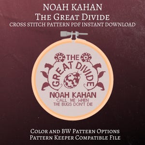 May include: A cross-stitch pattern featuring the text "THE GREAT DIVIDE" and "NOAH KAHAN" in burgundy thread on a light beige background, held in a wooden embroidery hoop. The design includes floral accents and the phrase "CALL ME WHEN THE BUGS DON'T DIE".
