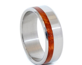 May include: A silver titanium ring with a thin band of reddish-brown wood inlay.