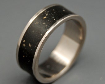 May include: A black and silver wedding band with a textured black band and a smooth silver band.