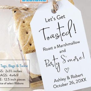 May include: A clear cellophane bag contains a s'more with a white tag that reads "Let's Get Toasted!" with the names Ashley & Robert and the date October 26, 20XX. The kit includes tags, bags, and twine. The tags are 2x3.5 inches.