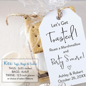 May include: A clear cellophane bag tied with twine, containing a s'mores kit. A white tag reads "Let's Get Toasted!" with event details. The kit includes graham crackers, marshmallows, and chocolate.