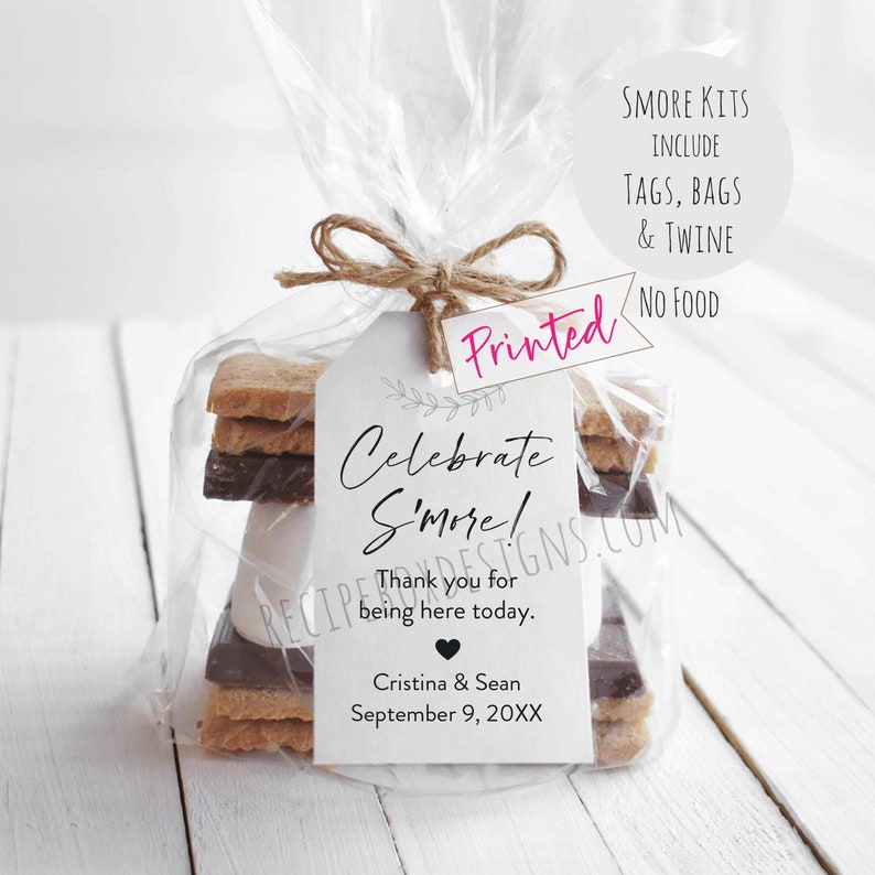 May include: A white tag with black text that reads "Celebrate S'more!" and "Thank you for being here today."  The tag also includes the names "Cristina & Sean" and the date "September 9, 20XX". The tag is tied to a clear plastic bag containing graham crackers, chocolate squares, and marshmallows.