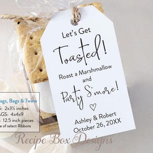 May include: A clear cellophane bag tied with twine, containing graham crackers and chocolate, with a white tag that reads "Let's Get Toasted!" and "Party S'more!" with a heart. The tag also includes a date and names.