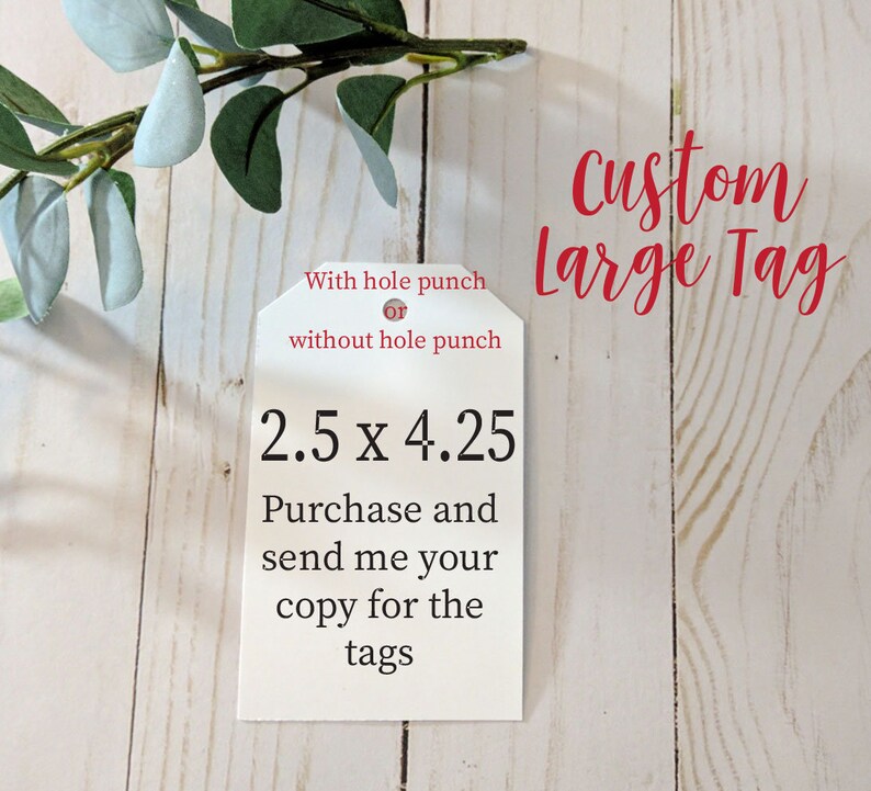 May include: White tag with the text "Custom Large Tag" in red. The tag is 2.5 inches by 4.25 inches. The text "With hole punch or without hole punch" is also on the tag. The tag is on a wooden surface.