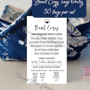 May include: A blue and white floral bowl cozy with a tag that says "Bowl Cozy Handmade with Love". The tag also includes care instructions for washing and drying the cozy. The tag says "100% Cotton Materials" and "Easy Care Instructions".