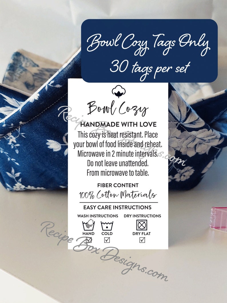 May include: A blue and white floral bowl cozy with a tag that says "Bowl Cozy Handmade with Love". The tag also includes care instructions for washing and drying the cozy. The tag says "100% Cotton Materials" and "Easy Care Instructions".
