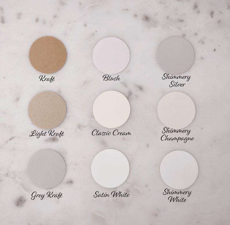 May include: Nine round paper samples in different colors and finishes, including Kraft, Blush, Shimmery Silver, Light Kraft, Classic Cream, Shimmery Champagne, Grey Kraft, Satin White, and Shimmery White.