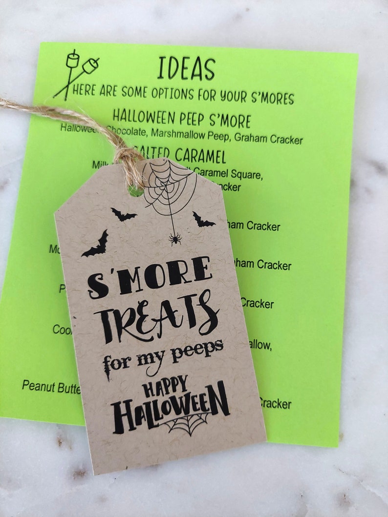 A Halloween S'more Treat Tag shown with twine. S'more Treats for my peeps. 
Instructions Paper with Ideas using Halloween peep marshmallows like ghost, Frankinstein, skulls and pumpkins. Happy Halloween