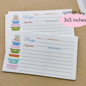 May include: A stack of vintage recipe cards with a colorful retro design featuring a stack of colorful bowls. The cards are 3x5 inches and have lines for writing down recipes, ingredients, serving size, preheat/cook time, and from the kitchen of.