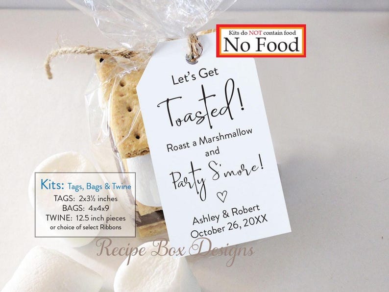 May include: A clear cellophane bag tied with twine, containing graham crackers and marshmallows, with a white tag that reads "Let's Get Toasted!" and includes a date. The tag is 2x3.5 inches. The kit does not contain food.