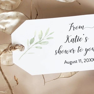 May include: White gift tag with a green watercolour leaf design. The text reads "from Katie's shower to yours August 11, 20XX".