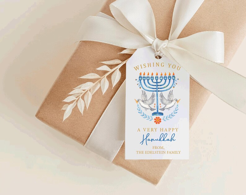 May include: A gift box wrapped in brown paper with a white ribbon and a decorative tag. The tag features a blue menorah, doves, and the text "Wishing You A Very Happy Hanukkah".