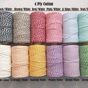 May include: A collection of twelve spools of 4-ply cotton twine in various colors, including black/white, brown/white, red/white, pink/white, and teal/white. The text "4 Ply Cotton" is at the top, and color names are listed below each spool.