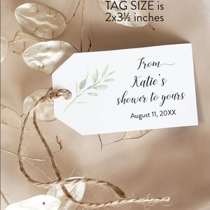 May include: A white gift tag with a green leafy branch design. The tag is tied with twine and has the text "from Katie's shower to yours" and "August 11, 20XX". The tag size is 2x3 1/2 inches.