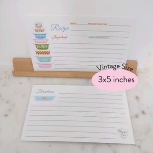 May include: A set of two vintage-style recipe cards with a blue and white floral design. The top card has a stack of colorful bowls and the text "Recipe" and "Ingredients". The bottom card has a single bowl and the text "Directions". The cards are 3x5 inches.