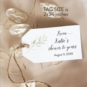 May include: A white tag with a green leafy branch design. The tag is tied with twine and has the text "from Katie's shower to yours" and "August 11, 20XX". The tag size is 2x3 1/2 inches.
