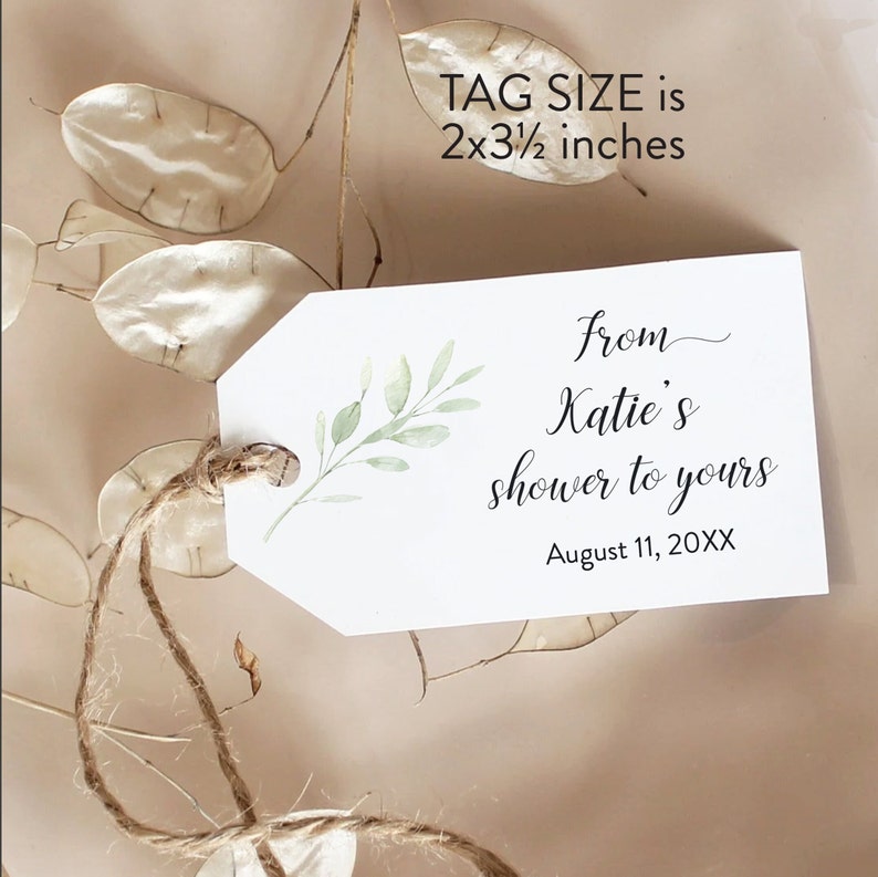 May include: A white tag with a green leafy branch design. The tag is tied with twine and has the text "from Katie's shower to yours" and "August 11, 20XX". The tag size is 2x3 1/2 inches.
