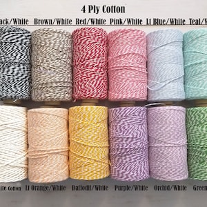May include: A collection of twelve spools of 4-ply cotton twine in various colors. The color combinations include black/white, brown/white, red/white, pink/white, light blue/white, and teal/white. Additional colors are very white, light orange/white, daffodil/white, purple/white, orchid/white, and green/white.